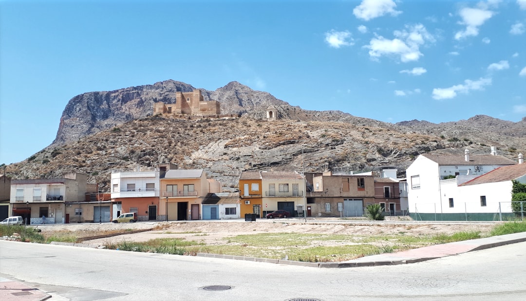 Small town nestled at the base of a large mountain.