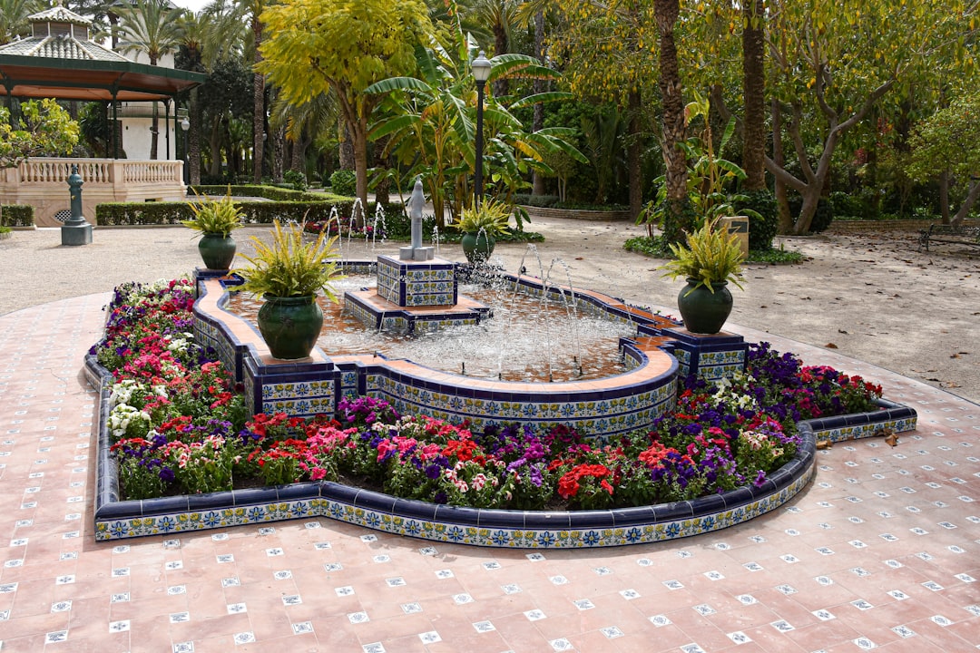 Beautiful fountain surrounded by colorful flowers.