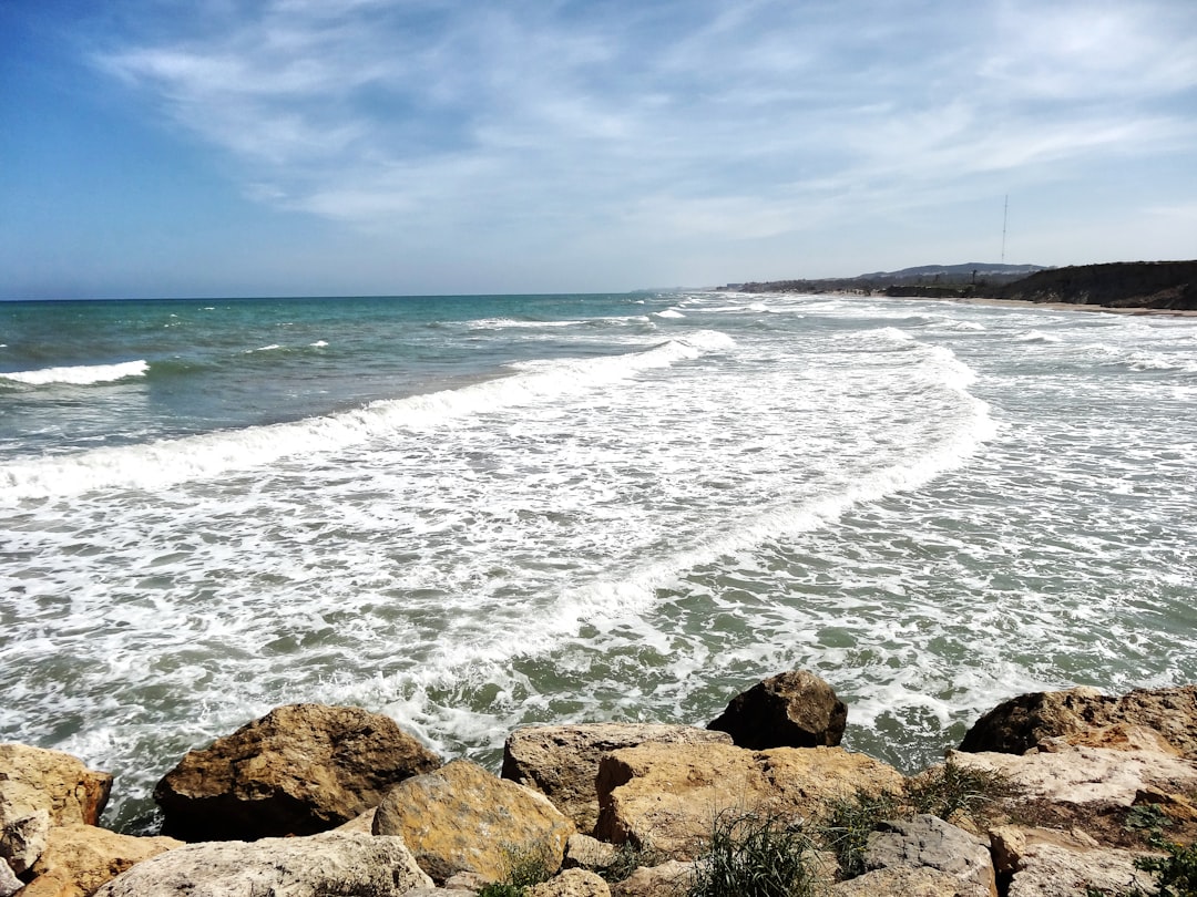 a view of the ocean from a rocky shore